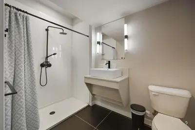 a bathroom with a toilet and a sink and a shower at Modern 2BR, 1BA Apartment in Great Location in Philadelphia