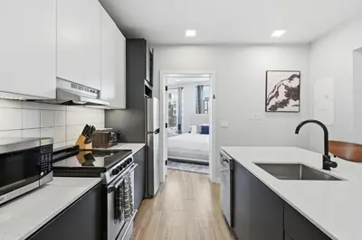 a kitchen with a sink and a stove top oven at Modern 2BR, 1BA Apartment in Great Location in Philadelphia