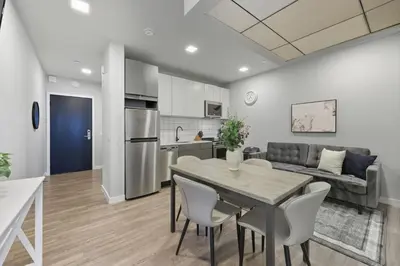 a kitchen and living room with a table and chairs at Cozy 1BR Apartment in Philly Prime Location in Philadelphia