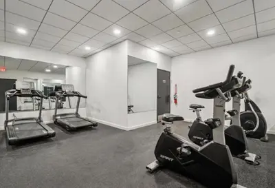 a gym with treadmills and ellipticals in a room at Cozy 1BR Apartment in Philly Prime Location in Philadelphia