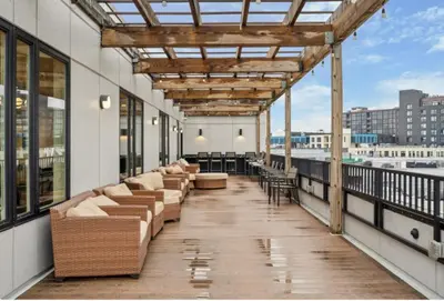 a balcony with couches and tables on a building at Cozy 1BR Apartment in Philly Prime Location in Philadelphia