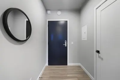 a hallway with a black door and a mirror at Cozy 1BR Apartment in Philly Prime Location in Philadelphia