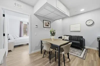 a dining room and living room with a table and chairs at Sleek 1BR apartment in Philly in Philadelphia