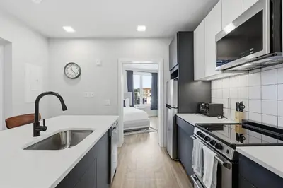 a kitchen with white counters and a sink at Bright Modern 2BR Apartment in Prime Location in Philadelphia