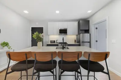 a kitchen with a table and four chairs at Contemporary 2BR Apartment Near Everything in Philadelphia