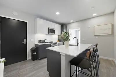 a kitchen with a white counter and a kitchen island at Contemporary 2BR Apartment Near Everything in Philadelphia