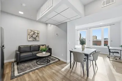 a living room with a couch and a table at Bright urban studio, fully furnished in Philadelphia