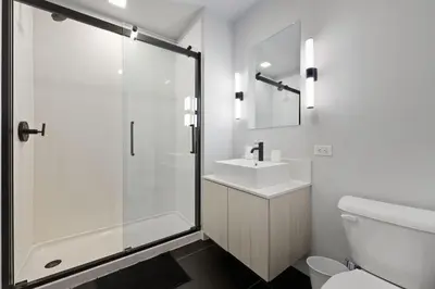 a bathroom with a shower and a sink and a toilet at Bright urban studio, fully furnished in Philadelphia
