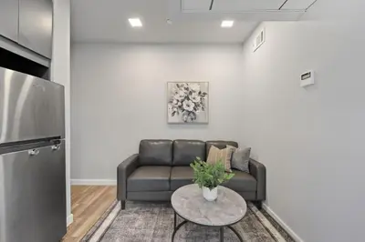 a living room with a couch and a table at Bright urban studio, fully furnished in Philadelphia