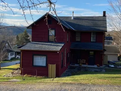 a red house with a black roof at Zen in Narrowsburg Retreat near Town in Narrowsburg