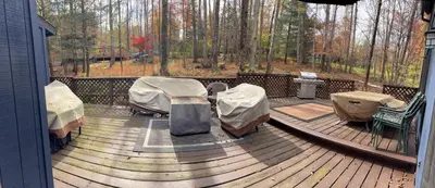 a deck with two beds and a table on it at Ambro's Place in Lake Ariel