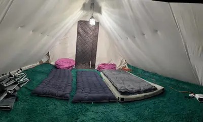 a bed in a tent with a mattress in it at Ambro's Place in Lake Ariel