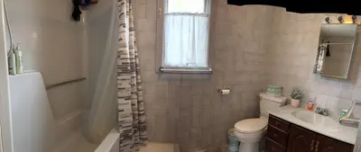a bathroom with a tub and a toilet and a sink at Ambro's Place in Lake Ariel