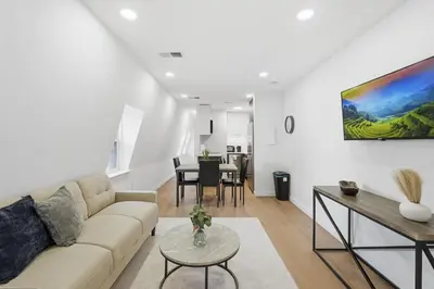 a living room with a couch and a table at A Modern 1BR Oasis in Carriage House in Philadelphia