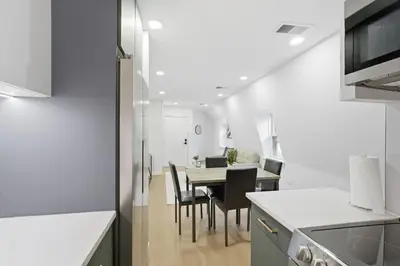 a kitchen and dining room with a table and chairs at A Modern 1BR Oasis in Carriage House in Philadelphia