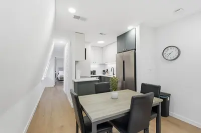 a kitchen and dining room with a table and chairs at A Modern 1BR Oasis in Carriage House in Philadelphia