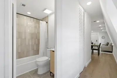 a bathroom with a toilet and a bath tub at A Modern 1BR Oasis in Carriage House in Philadelphia