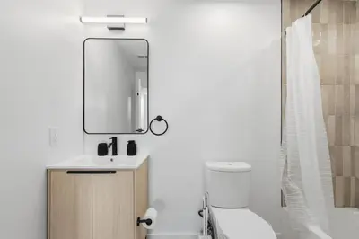 a bathroom with a sink and a mirror at Carriage House Sleek 1BR Apartment in Philadelphia