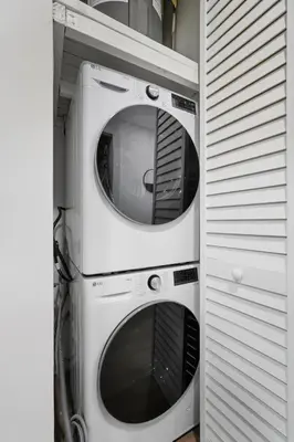 two washing machines stacked on top of each other at Carriage House Sleek 1BR Apartment in Philadelphia