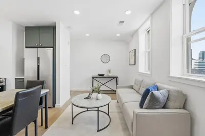a living room with a couch and a table at Cozy, Modern Living at Carriage House in Philadelphia