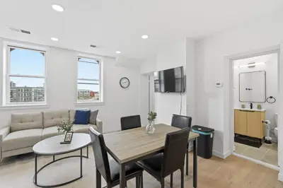 a living room with a table and a couch at Cozy, Modern Living at Carriage House in Philadelphia