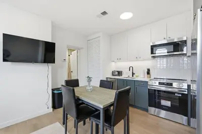 a kitchen with a table and chairs in a room at Cozy, Modern Living at Carriage House in Philadelphia