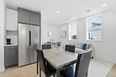 a kitchen and dining room with a table and chairs at Cozy, Modern Living at Carriage House in Philadelphia