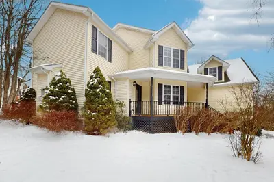a house with two christmas trees in the snow at The Nest in Long Pond