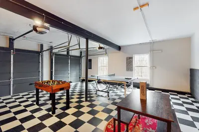 a room with a ping pong table in a room at The Nest in Long Pond