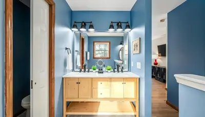 a bathroom with a sink and a mirror at Epic Poconos Pad - Pool - Hot Tub - Gym - Golf Sim in East Stroudsburg