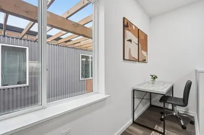 a home office with a desk and windows at Fully equipped apartment in great location in Philadelphia