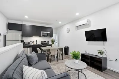 a living room with a couch and a kitchen at Fully equipped apartment in great location in Philadelphia