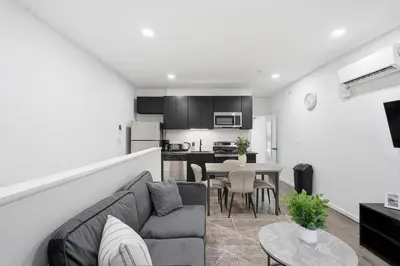 a living room and kitchen with a couch and a table at Fully equipped apartment in great location in Philadelphia