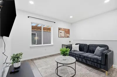 a living room with a black couch and a table at Fully equipped apartment in great location in Philadelphia