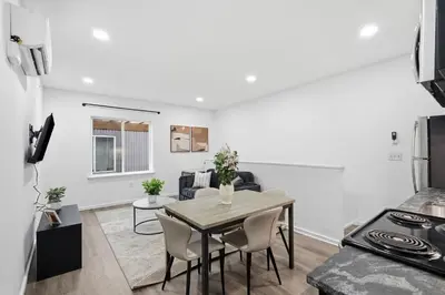 a kitchen and living room with a table and chairs at Fully equipped apartment in great location in Philadelphia