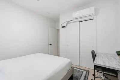 a bedroom with a bed and a desk and a window at Sleek apartment with modern amenities in Philadelphia