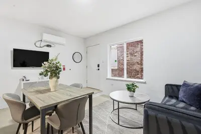 a living room with a table and a couch at Sleek apartment with modern amenities in Philadelphia