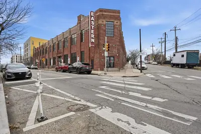 an intersection of an empty street in front of a brick building at Sleek apartment with modern amenities in Philadelphia