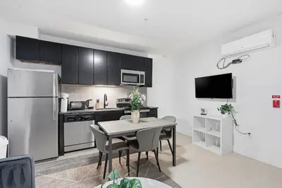 a kitchen and dining room with a table and a refrigerator at Sleek apartment with modern amenities in Philadelphia