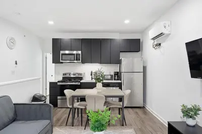 a kitchen and living room with a table and chairs at Sleek city apartment with modern finishes in Philadelphia