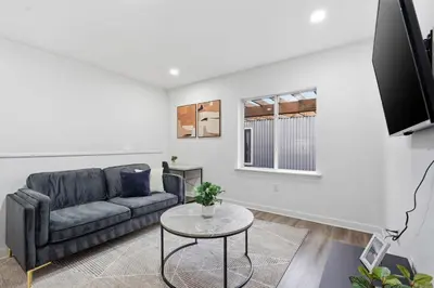 a living room with a couch and a table at Contemporary apartment with amenities in Philadelphia