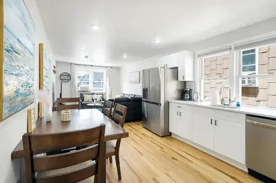 a kitchen and living room with a table and a dining room at Family Villa Close to NYC Attractions and Airport in Bayonne