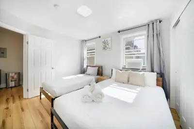 a bedroom with two beds and a window at Family Villa Close to NYC Attractions and Airport in Bayonne