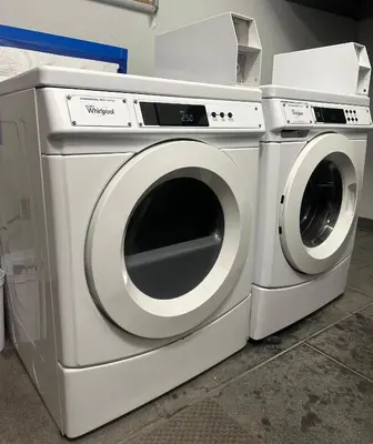 two washing machines are sitting next to each other at Minimalist Midtown West Studio in Central Manhattan in New York