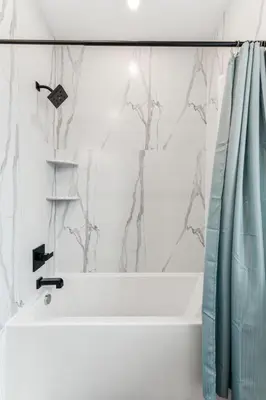 a bathroom with a tub and a shower curtain at Modern 3BR Walk to Museums in Philadelphia