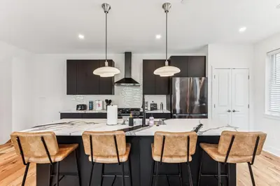 a kitchen with a large island with bar stools at Modern 3BR Walk to Museums in Philadelphia