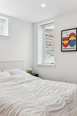 a white bed in a white bedroom with a window at Modern 3BR Walk to Museums in Philadelphia