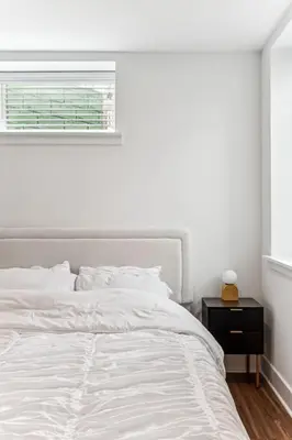 a white bedroom with a bed and a window at Modern 3BR Walk to Museums in Philadelphia