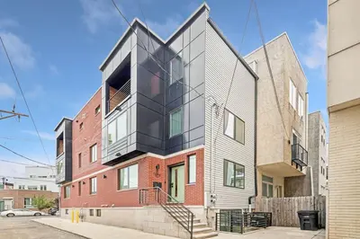a house with a glass facade on a street at Modern 3BR Walk to Museums in Philadelphia