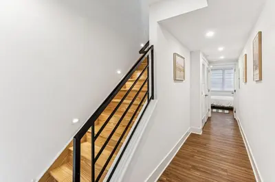 a staircase in a house with white walls and wood floors at Modern 3BR Walk to Museums in Philadelphia